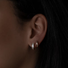 14k yellow gold baguette diamond huggies on model