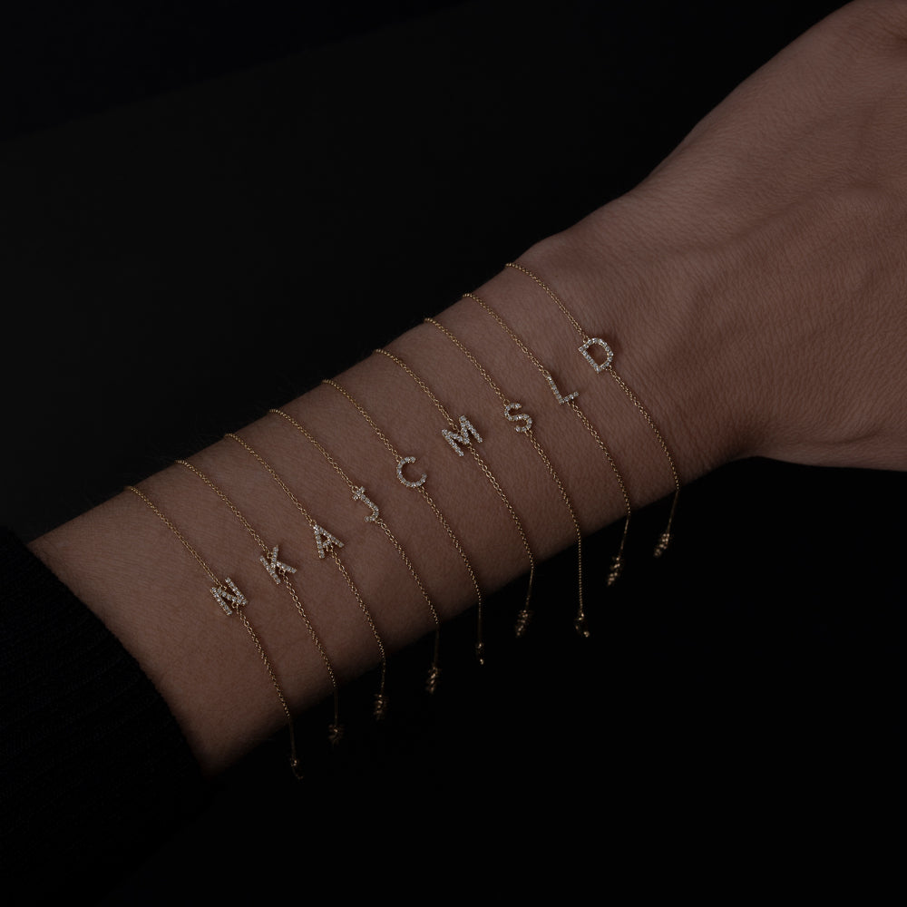 14k yellow gold diamond initial bracelets on model