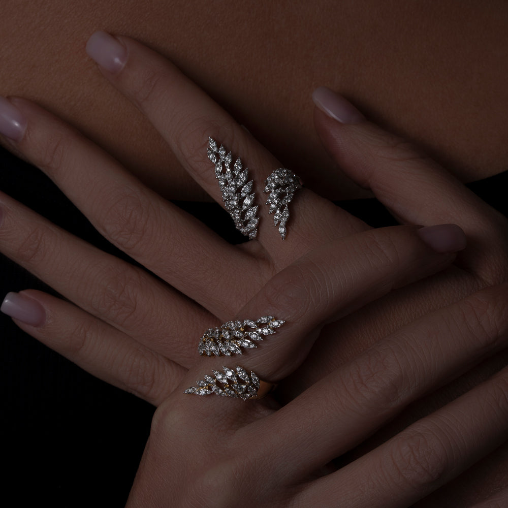 Diamond Wing Rings in white and yellow gold on model