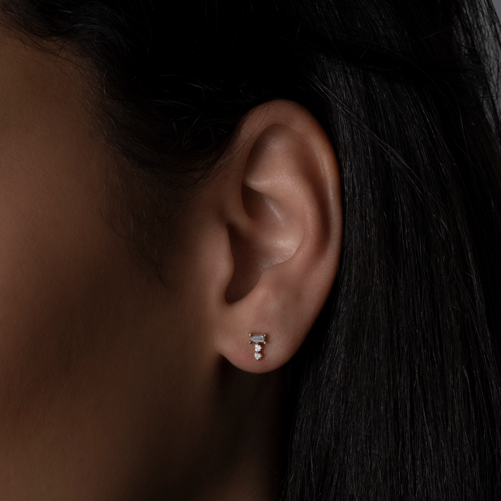 14k yellow gold baguette and round diamond cluster stud earrings on model