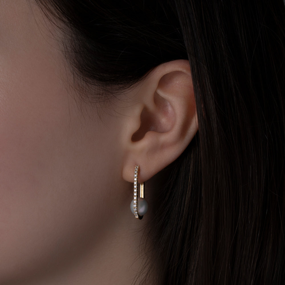 14k yellow gold pearl and diamond hoops on model ear