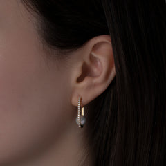 14k yellow gold pearl and diamond hoops on model ear