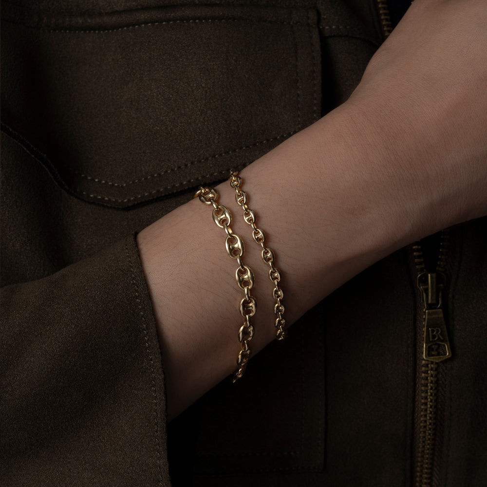 Gold puffed mariner bracelets in two sizes on model