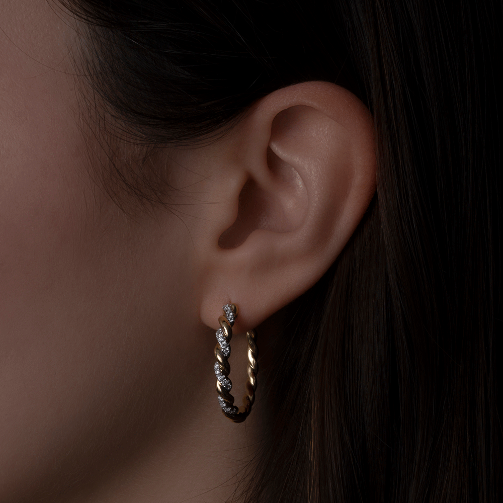 Twisted Gold and Diamond Hoops showcasing design details on model