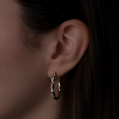 Twisted Gold and Diamond Hoops showcasing design details on model